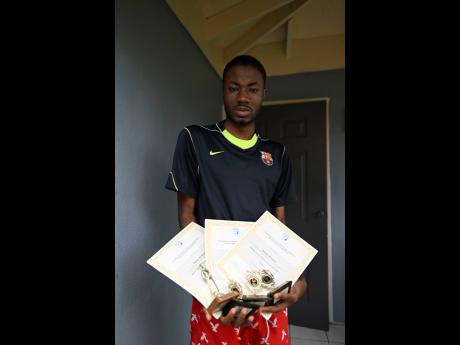 Ramone shows off some of his trophies and certificates.
