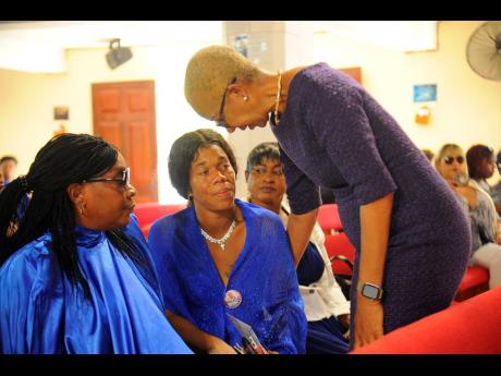Education minister Fayval Williams (right) offers condolences to Danielle’s mother Sudiene Mason (centre).