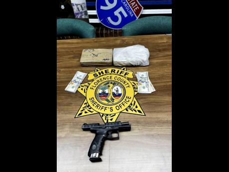 Credit: via Florence County Sheriff’s Office The gun and cocaine reportedly taken from the vehicle Mad Cobra was driving.