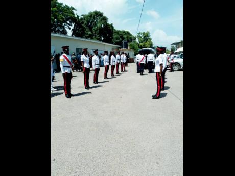 Members of the Jamaica Constabulary Force form a guard at honour  at the funeral for Romone Evans, which was held at  the Family of God Seventh-day Adventist Church. 58 Brunswick Avenue, Spanish Town, St. Catherine, yesterday.