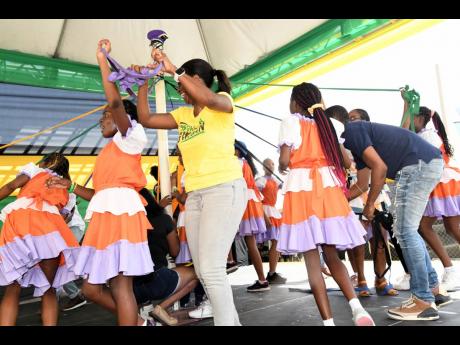 Credit: Rudolph Brown Members of the St Theresa Dance Group perform the maypole dance with their parents.