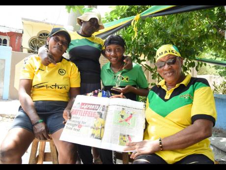 Members of Reggae Girl Trudi Carter’s family (from left) Lucille Hamilton, mom; Jean Hamilton, aunt; Ajae Edwards, cousin; and Patricia Hamilton, aunt, show newspaper clippings of stories about Trudi.