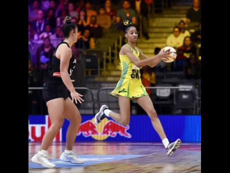 Sunshine Girls goal keeper Shamera Sterling (right) grabs onto a ball ahead of her New Zealand opponent during a Pool G second-round Netball World Cup game at the Cape Town International Convention Centre in Cape Town, South Africa, on Thursday morning.