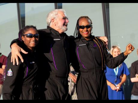 Space tourists, from left, Anastatia Mayers, Jon Goodwin and Keisha Schahaff pose for photos before boarding their Virgin Galactic flight at Spaceport America, near Truth or Consequences, N.M., Thursday, Aug. 10, 2023. Virgin Galactic is taking its first space tourists on a long-delayed rocket ship ride. (AP Photo/Andrés Leighton)