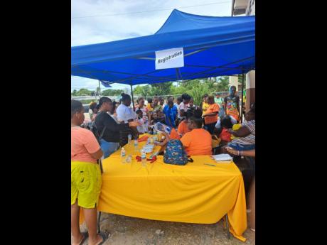 Persons signing up for services at the fair, which was held at the Lauriston Holiness Temple in St Catherine on Friday.