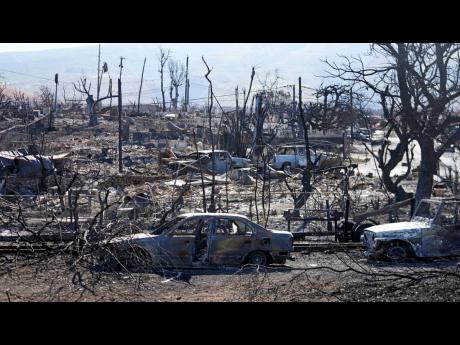 Destroyed homes and cars are shown in Lahaina, Hawaii. (AP Photo/Rick Bowmer)