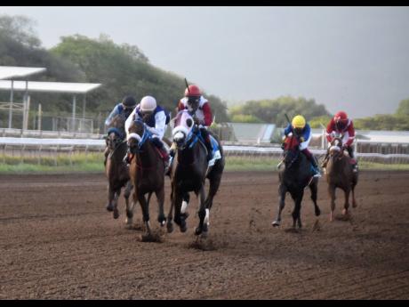 Outbidder, ridden by Reyan Lewis, wins the second running of the Liu Chie Poo Trophy over a mile for three-year-old and upwards open allowance stakes at Caymanas Park last Saturday.