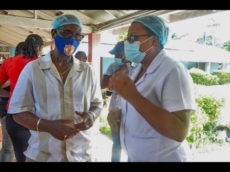 Minister of Local Government and Community Development, Desmond McKenzie (left), converses with Matron at the St Ann Infirmary, Alicia Drummond-Knight, during a tour of the facility last Friday.

 