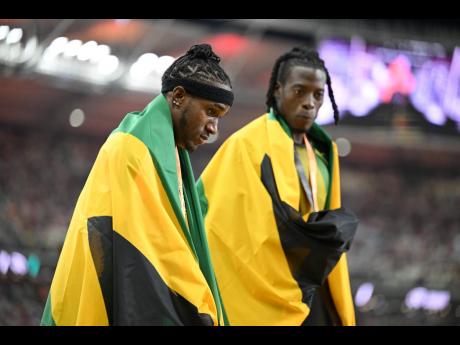 Jamaica's Wayne Pinnock (left) and Tajay Gayle celebrate winning the silver and bronze medals in the men's long jump.