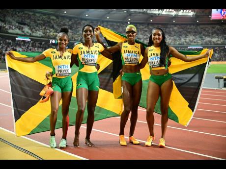 Jamaica’s Nickisha Pryce, Janieve Russell, Candice McLeod and Stacey Ann Williams celebrate winning the silver medal in the women’s 4x400 metres relay, at the World Athletics Championships in Budapest, Hungary, yesterday. The Netherlands won the event, with Great Britain getting the bronze.