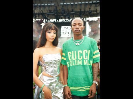 Recording artiste Armanii (right) strikes a pose with content creator, Shelby, who complemented his trendy streetwear with her urban glam look.