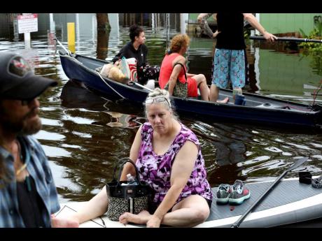 Residents of Twin City Mobile Home Park, a manufactured home community in flood zone A, navigate through the neighbourhood in high waters in St Petersburg.