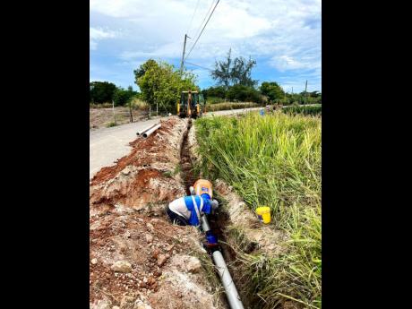 Credit: Contributed Workmen installing pipelines as part of the National Water Commission’s $90-million water supply project in Braco, Trelawny.