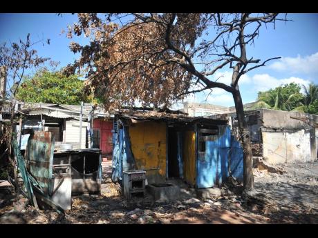 Credit: Nicholas Nunes/Photographer Burnt homes on Rum Lane tell the tale of the damage that was done as dwellings were firebombed about two weeks ago in central Kingston.