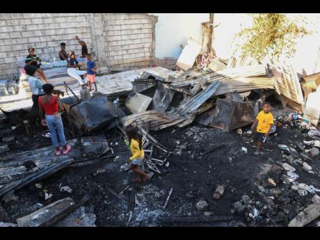Credit: Ricardo Makyn Rubble is all that’s left of Wilson’s home on Rum Lane, in Kingston.