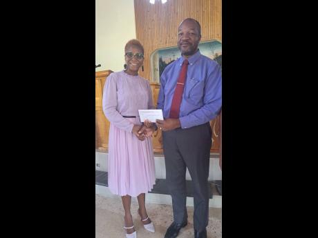 Monifa Chowder (left), a friend of the foundation, made the presentation to Colin Blake, principal of the Pollyground Primary School.