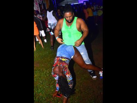 Dancer Bigz and a female patron showing off their moves.