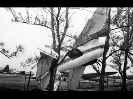 This aircraft got caught in the trees at the Norman Manley International Airport.