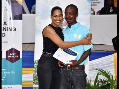 Blind farmer Tyrone Traille shares a moment with Member of Parliament for St Ann  South East Lisa Hanna.
