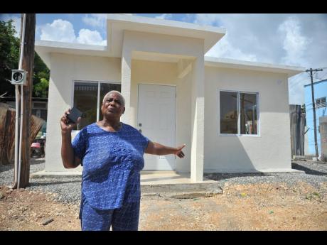 Marlene Bennett stands in front her new two-bedroom unit at Tower Street, Kingston. 