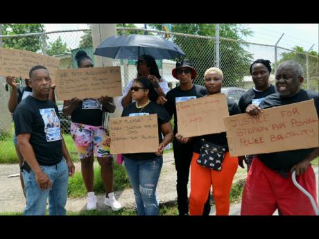 Protestors call for justice for Stephon Powell, as they demonstrated in front of the Vineyard Town Police Station yesterday.