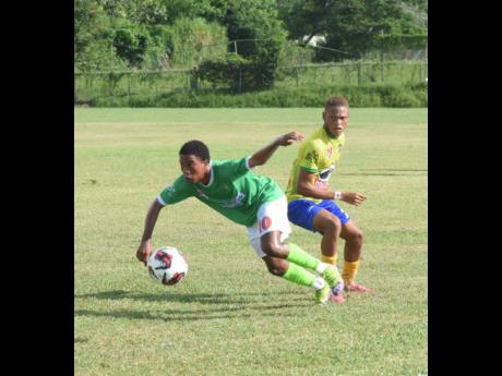 Frome Technical High’s Akeem Kongal (left) gets by Rusea’s High’s Davvaun Gibbon during the schoolboy ISSA/WATA daCosta Cup football match on Saturday at the Collin Miller Sports Complex in Lucea. Rusea’s won1-0.
