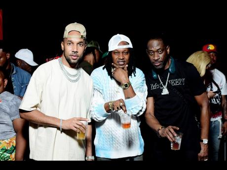 Bishop Escobar (centre) celebrates with legendary performers Baby Cham (left) and Bounty Killer.