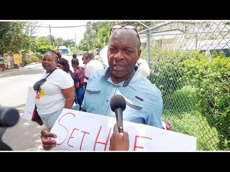 Pastor Dexter Johnson, national director for Jamaica Youth For Christ, calls for information on missing entertainer Stephanie ‘Medikk’ Williams, during a protest outside the Constant Spring Police Station in St Andrew yesterday.