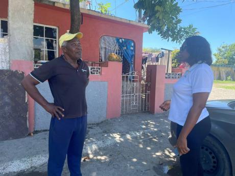 George Williams (left) Seaview resident, chats with Aretha McFarlane, operations officer at the NSWMA. 