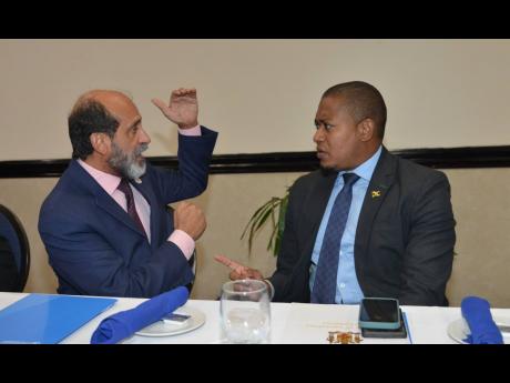 Credit: Kenyon Hemans Dr Crispim Moreira (left), FAO representative for Jamaica, The Bahamas and Belize, speaks with Minister of Agriculture, Fisheries and Mining, Floyd Green during the launch of the Rural Livelihoods Through Resilient Agri-food system launch at the Pegasus Hotel in St Andrew on Tuesday.