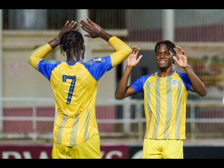 Credit: concacaf.com Harbour View’s Jahshaun Anglin (left) celebrates Matthew Coke’s goal in the opening Concacaf Caribbean Cup game against Dunbeholden FC at Sabina Park in August. Harbour View won 1-0.