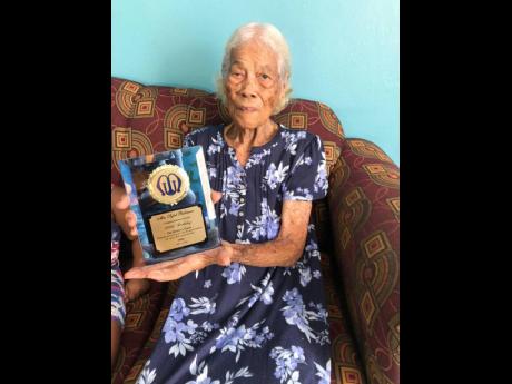 Sybil Robinson showing off her award from the church’s Mother’s Union, in honour of her birthday.