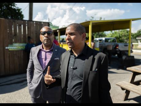 Mayor of Kingston Delroy Williams (right) addresses the media about the closing of ‘Crab Circle’. Looking on is Robert Hill, CEO of the Kingston and St Andrew Municipal Corporation. 