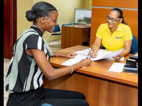 Credit: Contributed Supervisor Karen Cobourne (right) shares a light moment with a colleague on a rare occasion when she is in office.
