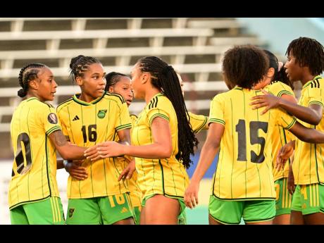 Jamaica’s Melissa Johnson (left) celebrates scoring their first goal with teammates.