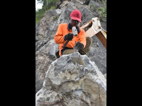 Scott is reluctant to use mechanical drills to crack the boulders, as the vibration may loosen more of them.