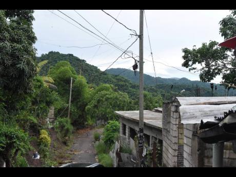 A section of Cottage Hill, rural St Andrew that, despite the presence of electricity poles, does not have power.