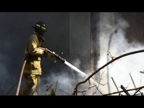 A firefighter carries out cooling-down operations at the Central Sorting Office last month.
