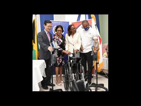 (From left) Chargé d’Affaires, Embassy of the Republic of Korea, Kim Jinwook; Assistant Regional Technical Director, Southeast Regional Health Authority, Major (retired) Dr Susan Wright; Administrator/Asset Manager, Kingston Public Hospital (KPH), Kathleen Cooper Brown; and President of the Korean International Cooperation Agency Alumni Association Jamaica Chapter, Andre Lindsey, look at medical equipment donated to the KPH by the Republic of Korea. The handover ceremony was held on Tuesday at the hospital.