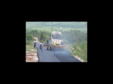 Workmen repair a section of roadway as part of the ongoing Essex Valley Agricultural Development Project in St Elizabeth.