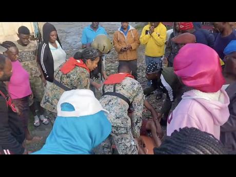 Credit: Contributed Photos JDF personnel tend to Henry as they prepare to carry him to the helicopter.