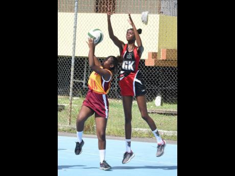 Credit: Ian Allen Tianna Reid (right) of Glenmuir High tries to block a shot from Assia Whyte of Tacky High during their ISSA rural schoolgirls’ netball match at GC Foster College yesterday. Glenmuir won 76-7.