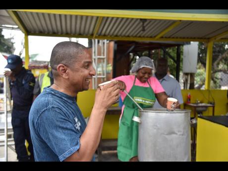 Kingston Mayor Delroy Williams enjoys a cup of soup at the new and improved Crab Circle.