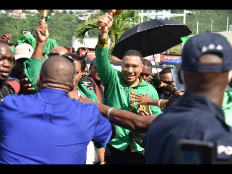 Prime Minister Andrew Holness arrives at the National Arena in St Andrew for the Jamaica Labour Party’s 80th annual conference. 