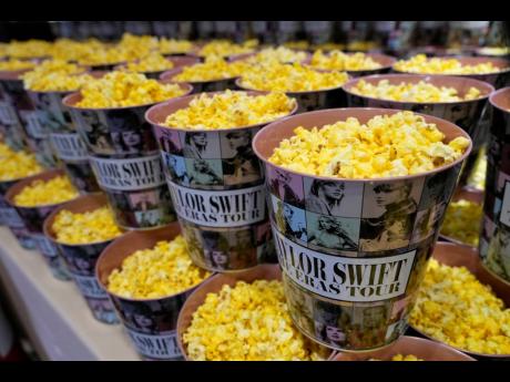 Popcorn in decorative containers is on display prior to the world premiere of the concert film ‘Taylor Swift: The Eras Tour’.