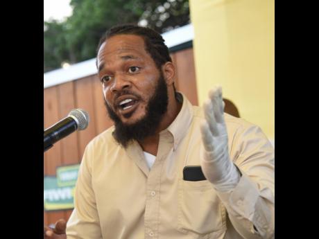 Kazrae Gray, who passed himself off as health inspector Randy Bucktoe, speaks at the reopening ceremony for the popular Crab Circle spot in Kingston last Thursday.