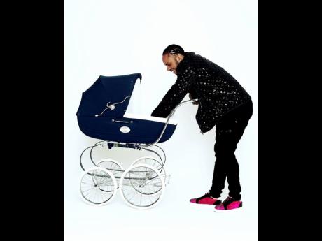 Credit: Contributed Dexta Daps sharing a special moment with his son