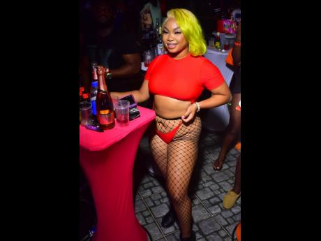 With liqour on her table and good vibe flowing, the red-hot Jazz Grooves enjoys a cool afternoon at the recently held  Floss 360 Stringz Pool Party in Red Hills, St Andrew.