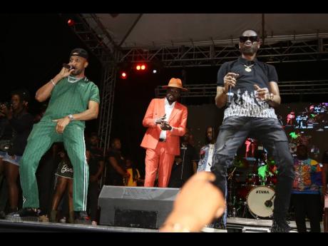 Beenie Man (centre) told the crowd that after seeing Cham (left) and Bounty on stage, he had to join in their festive set.
