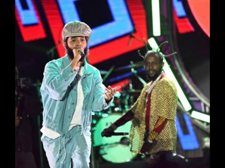 Popcaan with Proteje on stage.